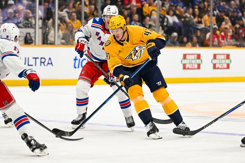 Dec 21, 2025; Nashville, Tennessee, USA;  Nashville Predators right wing Michael McCarron (47) skates with the puck against the New York Rangers during the first period at Bridgestone Arena. Mandatory Credit: Steve Roberts-Imagn Images