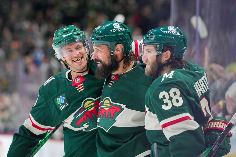 Nov 5, 2024; Saint Paul, Minnesota, USA; Minnesota Wild defenseman Zach Bogosian (24) celebrates his goal with defenseman Jon Merrill (4) against the Los Angeles Kings in the second period at Xcel Energy Center. Mandatory Credit: Brad Rempel-Imagn Images