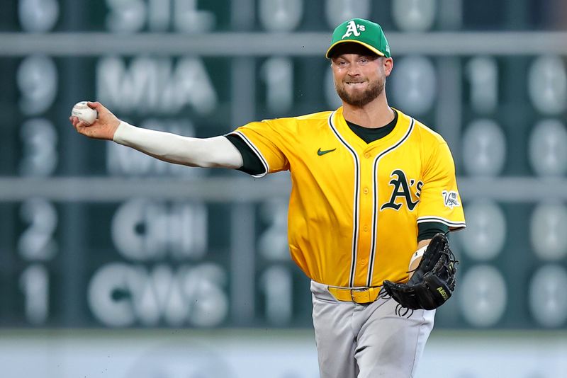 Jul 27, 2025; Houston, Texas, USA; Athletics shortstop Max Schuemann (12) throws to first for an out against the Houston Astros during the seventh inning at Daikin Park. Mandatory Credit: Erik Williams-Imagn Images