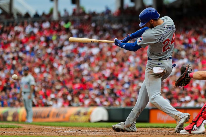 Jun 8, 2024; Cincinnati, Ohio, USA; Chicago Cubs outfielder Cody Bellinger (24) hits a single against the Cincinnati Reds in the ninth inning at Great American Ball Park. Mandatory Credit: Katie Stratman-USA TODAY Sports