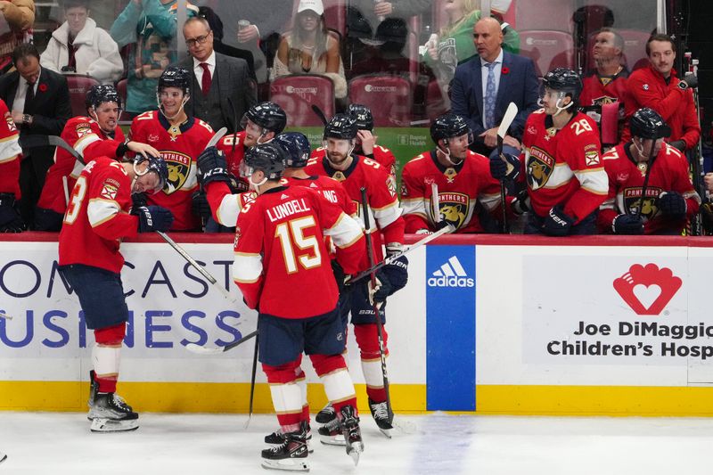 Nov 10, 2023; Sunrise, Florida, USA; Florida Panthers center Carter Verhaeghe (23) celebrates with teammates after scoring a goal against the Carolina Hurricanes during the third period at Amerant Bank Arena. Mandatory Credit: Jasen Vinlove-USA TODAY Sports