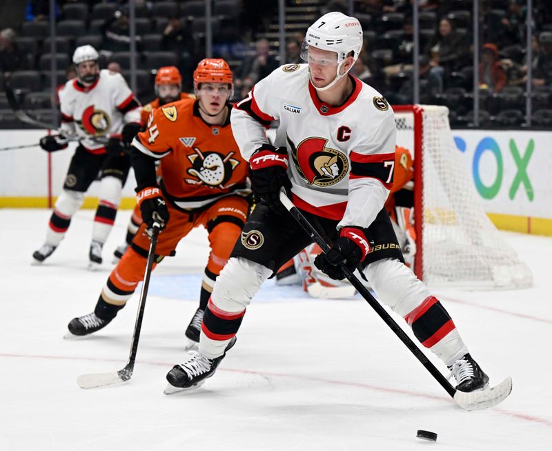 Dec 1, 2024; Anaheim, California, USA;  Ottawa Senators left wing Brady Tkachuk (7) controls the puck with pressure from Anaheim Ducks defenseman Pavel Mintyukov (34) feting the first period at Honda Center. Mandatory Credit: Alex Gallardo-Imagn Images