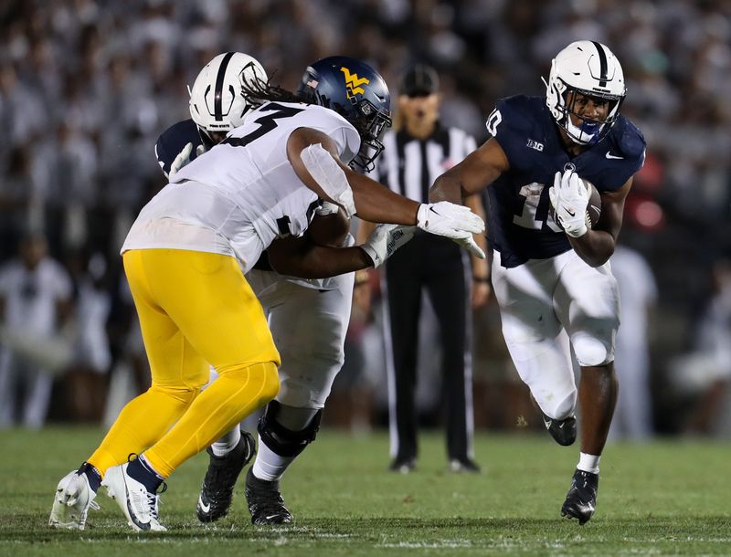 Sep 2, 2023; University Park, Pennsylvania, USA; Penn State Nittany Lions running back Nicholas Singleton (10) runs the ball against the West Virginia Mountaineers during the fourth quarter at Beaver Stadium. Penn State won 38-15. Mandatory Credit: Matthew O'Haren-USA TODAY Sports