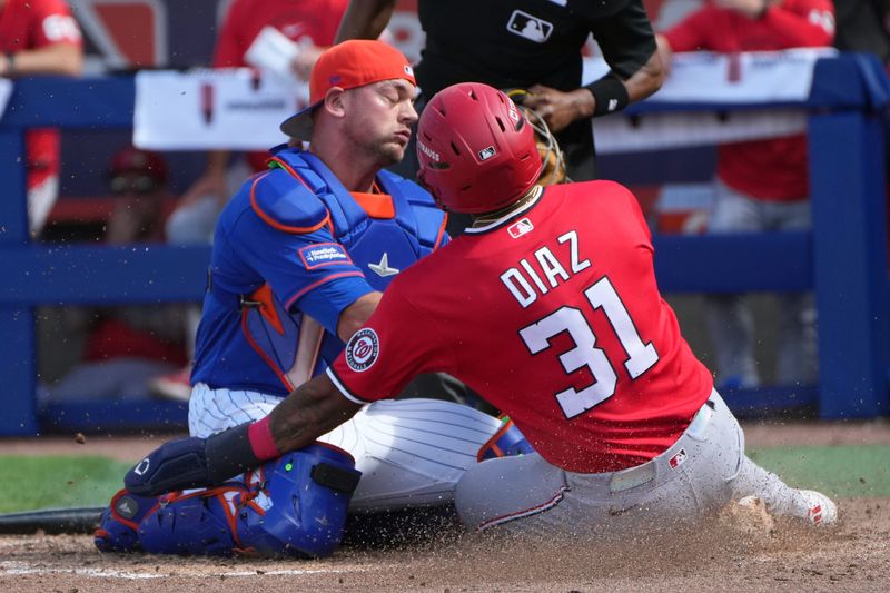 Feb 28, 2026; Port St. Lucie, Florida, USA;  Washington Nationals third baseman Randal Diaz gets tagged out at the plate by New York Mets catcher Ben Rortvedt (77) in the sixth inning at Clover Park. Mandatory Credit: Jim Rassol-Imagn Images