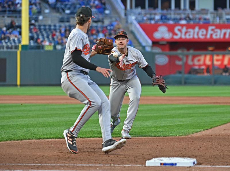 Apr 19, 2024; Kansas City, Missouri, USA; Baltimore Orioles first baseman Ryan Mountcastle (6) flips the ball to starting pitcher Dean Kremer (64) at first ball in the fourth inning against the Kansas City Royals at Kauffman Stadium. Mandatory Credit: Peter Aiken-USA TODAY Sports
