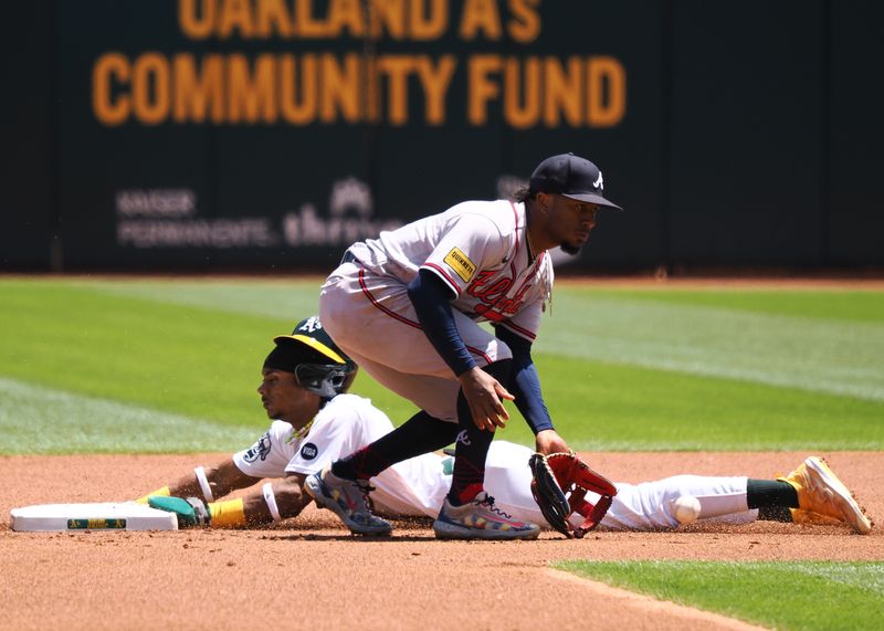 May 31, 2023; Oakland, California, USA; Oakland Athletics center fielder Esteury Ruiz (1) steals first base against Atlanta Braves second baseman Ozzie Albies (1) during the first inning at Oakland-Alameda County Coliseum. Mandatory Credit: Kelley L Cox-USA TODAY Sports