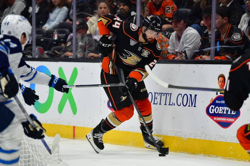 Jan 5, 2024; Anaheim, California, USA; Anaheim Ducks center Isac Lundestrom (21) moves the puck against the Winnipeg Jets during the second period at Honda Center. Mandatory Credit: Gary A. Vasquez-USA TODAY Sports