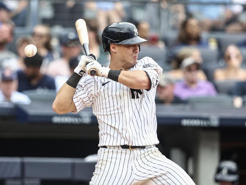 Jun 23, 2024; Bronx, New York, USA;  New York Yankees shortstop Anthony Volpe (11) leans back to avoid getting hit by the pitch in the eighth inning against the Atlanta Braves at Yankee Stadium. Mandatory Credit: Wendell Cruz-USA TODAY Sports