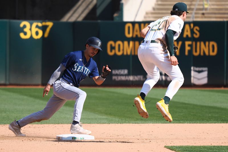 Sep 20, 2023; Oakland, California, USA; Seattle Mariners left fielder Sam Haggerty (0) steals second base against Oakland Athletics second baseman Zack Gelof (20) during the eighth inning at Oakland-Alameda County Coliseum. Mandatory Credit: Kelley L Cox-USA TODAY Sports