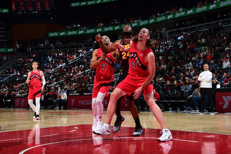 ATLANTA, GA - February 23: Kelly Olynyk #41 and Bruce Brown #11 of the Toronto Raptors battle for position with Bruno Fernando #24 of the Atlanta Hawks on February 23, 2024 at State Farm Arena in Atlanta, Georgia.  NOTE TO USER: User expressly acknowledges and agrees that, by downloading and/or using this Photograph, user is consenting to the terms and conditions of the Getty Images License Agreement. Mandatory Copyright Notice: Copyright 2024 NBAE (Photo by Scott Cunningham/NBAE via Getty Images)