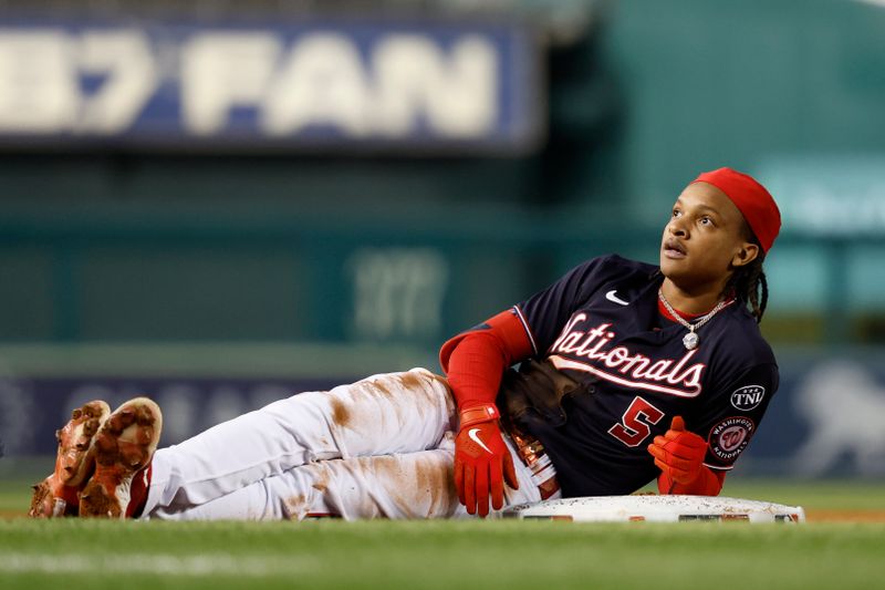 Sep 19, 2023; Washington, District of Columbia, USA; Washington Nationals shortstop CJ Abrams (5) lies at third base after hitting a triple against the Chicago White Sox during the first inning at Nationals Park. Mandatory Credit: Geoff Burke-USA TODAY Sports