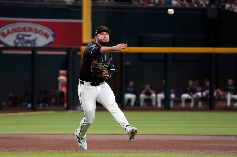 May 17, 2024; Phoenix, Arizona, USA; Arizona Diamondbacks third base Eugenio Suárez (28) makes the off balance throw against the Detroit Tigers for the out in the second inning at Chase Field. Mandatory Credit: Rick Scuteri-USA TODAY Sports