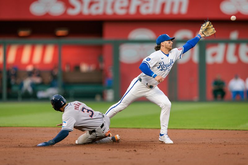 Apr 10, 2024; Kansas City, Missouri, USA; Kansas City Royals shortstop Bobby Witt Jr. (7) reaches for a throw as Houston Astros shortstop Jeremy Peña (3) slides into 2nd base during the second inning at Kauffman Stadium. Mandatory Credit: William Purnell-USA TODAY Sports