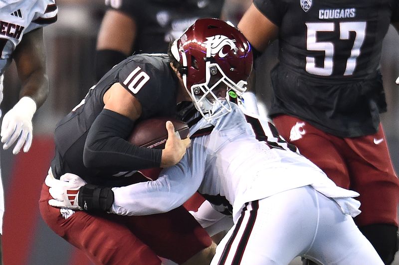 Sep 7, 2024; Pullman, Washington, USA; Washington State Cougars quarterback John Mateer (left) is tackled by Texas Tech Red Raiders linebacker Jacob Rodriguez (10) in the first half at Gesa Field at Martin Stadium. Mandatory Credit: James Snook-Imagn Images