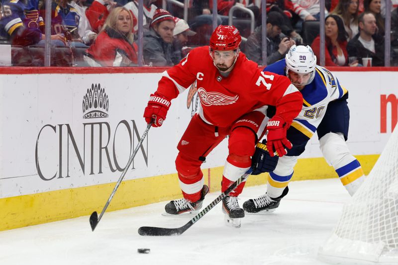 Feb 24, 2024; Detroit, Michigan, USA;  Detroit Red Wings center Dylan Larkin (71) skates with the puck chased by St. Louis Blues left wing Brandon Saad (20) in the second period at Little Caesars Arena. Mandatory Credit: Rick Osentoski-USA TODAY Sports