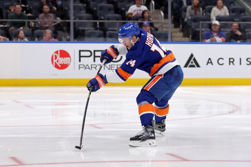 Jan 24, 2026; Elmont, New York, USA; New York Islanders center Bo Horvat (14) takes a shot against the Buffalo Sabres during the second period at UBS Arena. Mandatory Credit: Brad Penner-Imagn Images