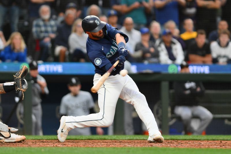 Jun 10, 2024; Seattle, Washington, USA; Seattle Mariners designated hitter Mitch Haniger (17) hits a 2-RBI single against the Chicago White Sox during the eighth inning at T-Mobile Park. Mandatory Credit: Steven Bisig-USA TODAY Sports