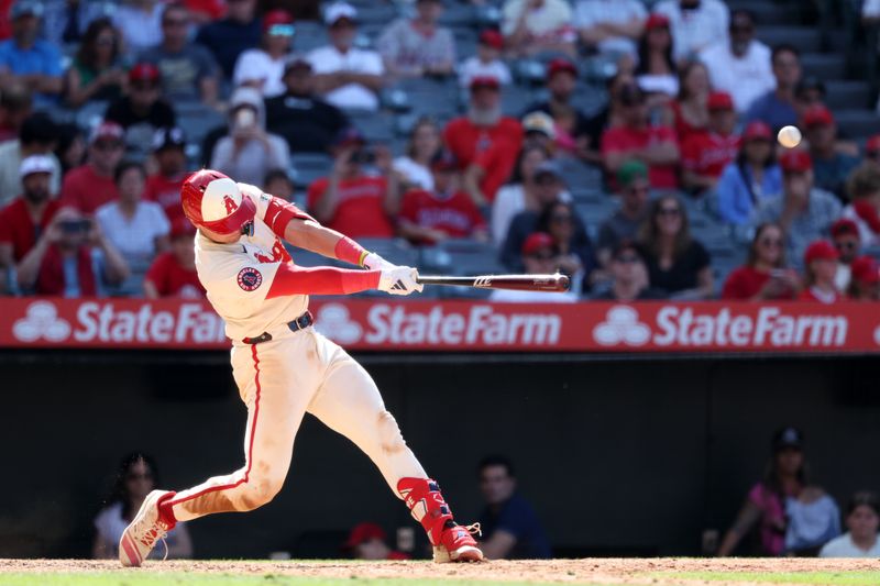 Jun 9, 2024; Anaheim, California, USA;  Los Angeles Angels catcher Logan O'Hoppe (14) hits a game winning 2-run home run in bottom of the ninth inning against the Houston Astros at Angel Stadium. Mandatory Credit: Kiyoshi Mio-USA TODAY Sports