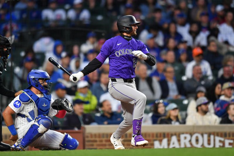 May 27, 2025; Chicago, Illinois, USA; Colorado Rockies third baseman Ryan McMahon (24) hits an RBI single during the fourth inning against the Chicago Cubs at Wrigley Field. Mandatory Credit: Patrick Gorski-Imagn Images