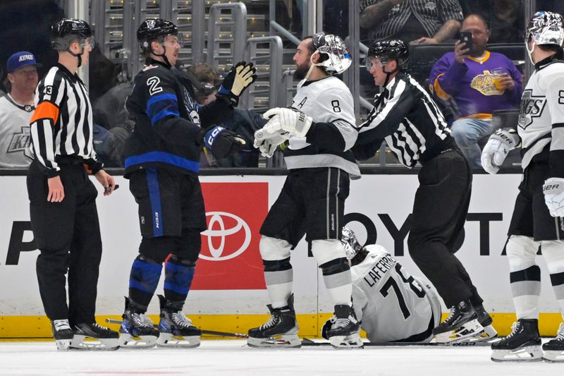 Jan 2, 2024; Los Angeles, California, USA; Officials separate Toronto Maple Leafs defenseman Simon Benoit (2) and Los Angeles Kings defenseman Drew Doughty (8) as tempers flair in the second period at Crypto.com Arena. Mandatory Credit: Jayne Kamin-Oncea-USA TODAY Sports