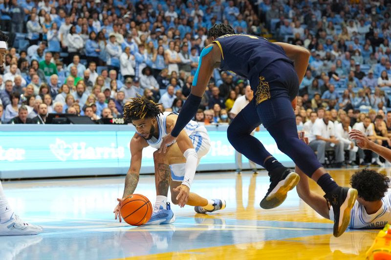 Jan 7, 2023; Chapel Hill, North Carolina, USA;  Notre Dame Fighting Irish guard Alex Wade (4) reaches for the ball against Notre Dame Fighting Irish guard J.J. Starling (1) during the first half at Dean E. Smith Center. Mandatory Credit: James Guillory-USA TODAY Sports