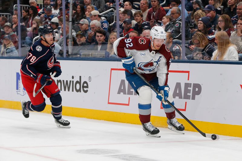 Oct 16, 2025; Columbus, Ohio, USA; Colorado Avalanche left wing Gabriel Landeskog (92) carries the puck as Columbus Blue Jackets defenseman Damon Severson (78) trails the play during the first period at Nationwide Arena. Mandatory Credit: Russell LaBounty-Imagn Images