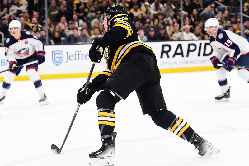 Nov 18, 2024; Boston, Massachusetts, USA;  Boston Bruins defenseman Charlie McAvoy (73) shoots the puck during the first period against the Columbus Blue Jackets at TD Garden. Mandatory Credit: Bob DeChiara-Imagn Images