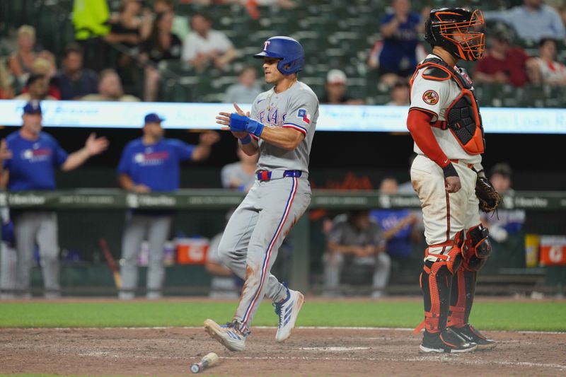 Jun 24, 2025; Baltimore, Maryland, USA; Texas Rangers outfielder Sam Haggerty (0) scores a run in the eighth inning to tie the game against the Baltimore Orioles at Oriole Park at Camden Yards. Mandatory Credit: Mitch Stringer-Imagn Images