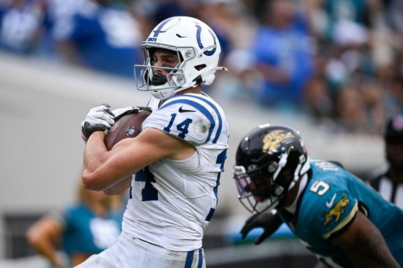 Indianapolis Colts wide receiver Alec Pierce (14) makes a touchdown catch against Jacksonville Jaguars safety Andre Cisco (5) during the second half of an NFL football game, Sunday, Oct. 6, 2024, in Jacksonville, Fla. (AP Photo/Phelan M. Ebenhack)