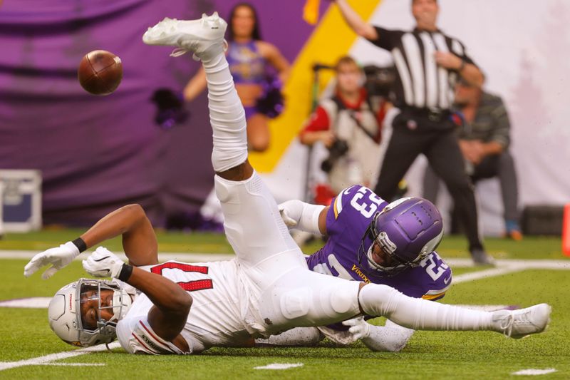 Minnesota Vikings cornerback Fabian Moreau (23) breaks up a pass intended for Arizona Cardinals wide receiver Zay Jones (17) during the second half of an NFL football game Sunday, Dec. 1, 2024, in Minneapolis. (AP Photo/Bruce Kluckhohn)