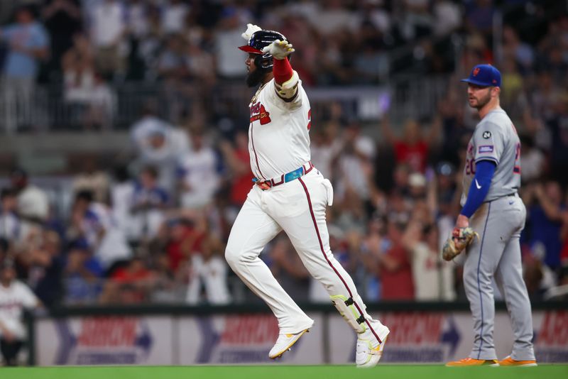 Sep 24, 2024; Atlanta, Georgia, USA; Atlanta Braves designated hitter Marcell Ozuna (20) celebrates after a home run past New York Mets first baseman Pete Alonso (20) in the fifth inning at Truist Park. Mandatory Credit: Brett Davis-Imagn Images