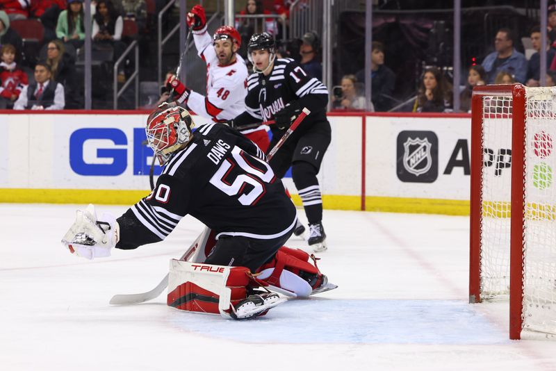 Mar 9, 2024; Newark, New Jersey, USA; New Jersey Devils goaltender Nico Daws (50) makes a save against the Carolina Hurricanes during the first period at Prudential Center. Mandatory Credit: Ed Mulholland-USA TODAY Sports