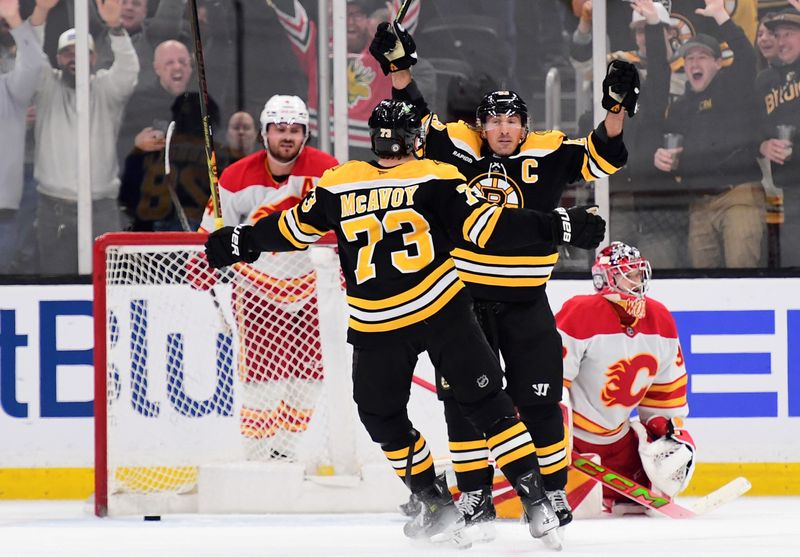 Nov 7, 2024; Boston, Massachusetts, USA;  Boston Bruins left wing Brad Marchand (63) and defenseman Charlie McAvoy (73) react after defeating the Calgary Flames in overtime at TD Garden. Mandatory Credit: Bob DeChiara-Imagn Images