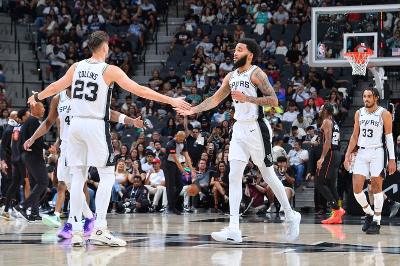 SAN ANTONIO, TX - APRIL 14: Julian Champagnie #30  high fives Zach Collins #23 of the San Antonio Spurs during the game against the Detroit Pistons on April 14, 2024 at the Frost Bank Center in San Antonio, Texas. NOTE TO USER: User expressly acknowledges and agrees that, by downloading and or using this photograph, user is consenting to the terms and conditions of the Getty Images License Agreement. Mandatory Copyright Notice: Copyright 2024 NBAE (Photos by Michael Gonzales/NBAE via Getty Images)