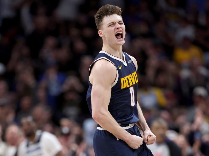 DENVER, COLORADO - APRIL 10: Christian Braun #0 of the Denver Nuggets a dunk against the Minnesota Timberwolves during the fourth quarter at Ball Arena on April 10, 2024 in Denver, Colorado. NOTE TO USER: User expressly acknowledges and agrees that, by downloading and or using this photograph, User is consenting to the terms and conditions of the Getty Images License Agreement.  (Photo by Matthew Stockman/Getty Images)