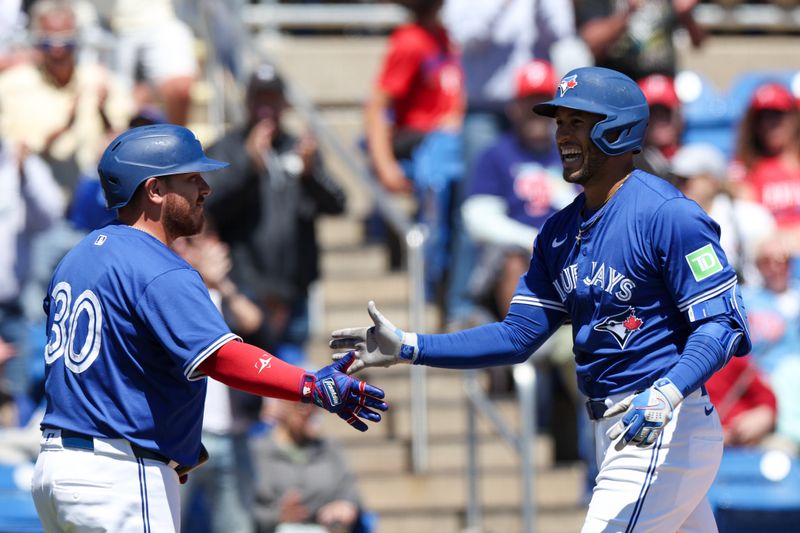 Mar 21, 2025; Dunedin, Florida, USA; Toronto Blue Jays outfielder George Springer (4) celebrates with catcher Alejandro Kirk (30) after hitting a three run home run against the Philadelphia Phillies in the third inning during spring training at TD Ballpark. Mandatory Credit: Nathan Ray Seebeck-Imagn Images