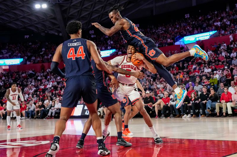 Jan 4, 2023; Athens, Georgia, USA; Auburn Tigers guard Allen Flanigan (22) lands on the head of Georgia Bulldogs center Frank Anselem (5) while playing defense during the second half at Stegeman Coliseum. Mandatory Credit: Dale Zanine-USA TODAY Sports