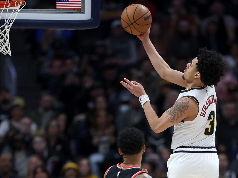 DENVER, COLORADO - FEBRUARY 10: Julian Strawther #3 of the Denver Nuggets lays in a basket against Anfernee Simons #1 of the Portland Trail Blazers in the third quarter at Ball Arena on February 10, 2025 in Denver, Colorado. NOTE TO USER: User expressly acknowledges and agrees that, by downloading and or using this photograph, User is consenting to the terms and conditions of the Getty Images License Agreement.  (Photo by Matthew Stockman/Getty Images)