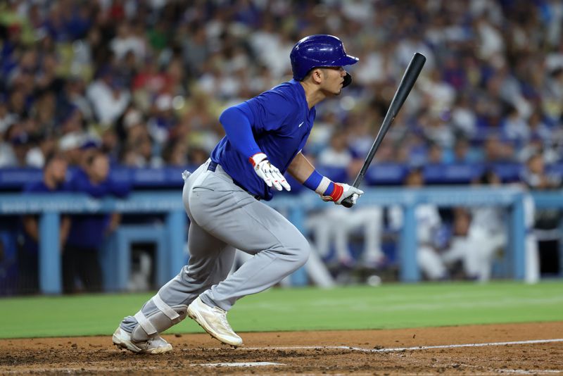 Sep 10, 2024; Los Angeles, California, USA;  Chicago Cubs designated hitter Seiya Suzuki (27) hits a RBI single during the eighth inning against the Los Angeles Dodgers at Dodger Stadium. Mandatory Credit: Kiyoshi Mio-Imagn Images