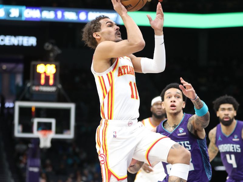 CHARLOTTE, NC - FEBRUARY 14: Trae Young #11 of the Atlanta Hawks drives to the basket during the game against the Charlotte Hornets on February 14, 2024 at Spectrum Center in Charlotte, North Carolina. NOTE TO USER: User expressly acknowledges and agrees that, by downloading and or using this photograph, User is consenting to the terms and conditions of the Getty Images License Agreement.  Mandatory Copyright Notice:  Copyright 2024 NBAE (Photo by Brock Williams-Smith/NBAE via Getty Images)