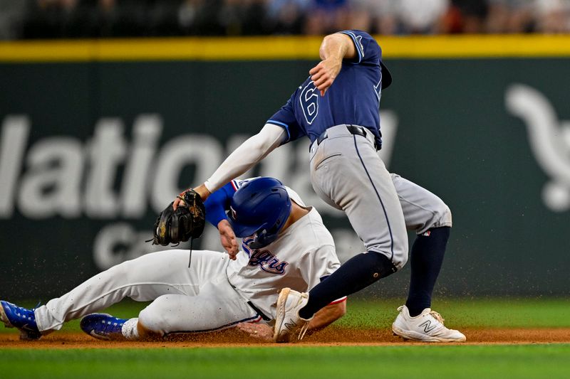 Jul 6, 2024; Arlington, Texas, USA; Tampa Bay Rays shortstop Taylor Walls (6) tags out Texas Rangers left fielder Wyatt Langford (36) on a steal attempt during the eighth inning at Globe Life Field. Mandatory Credit: Jerome Miron-USA TODAY Sports