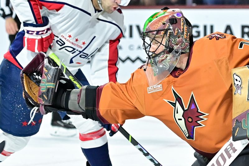 Jan 19, 2023; Tempe, Arizona, USA; Arizona Coyotes goaltender Karel Vejmelka (70) makes a glove save in the first period against the Washington Capitals at Mullett Arena. Mandatory Credit: Matt Kartozian-USA TODAY Sports