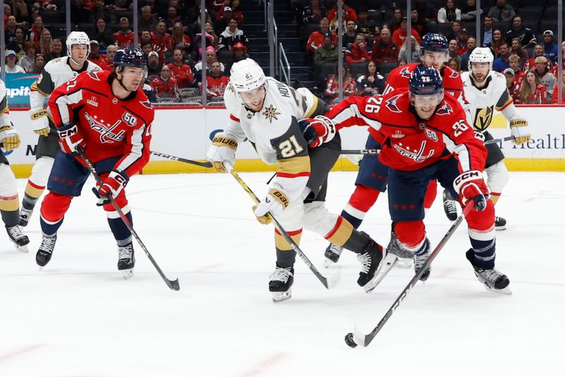 Oct 15, 2024; Washington, District of Columbia, USA; Washington Capitals center Nic Dowd (26) and Vegas Golden Knights center Brett Howden (21) battle for the puck in the first period at Capital One Arena. Mandatory Credit: Geoff Burke-Imagn Images