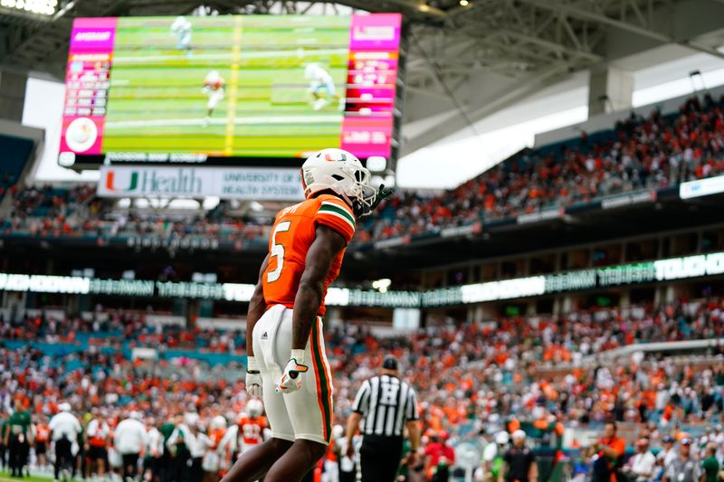 Oct 8, 2022; Miami Gardens, Florida, USA; Miami Hurricanes wide receiver Key'Shawn Smith (5) celebrates scoring a touch down against the North Carolina Tar Heels during the first half at Hard Rock Stadium. Mandatory Credit: Rich Storry-USA TODAY Sports