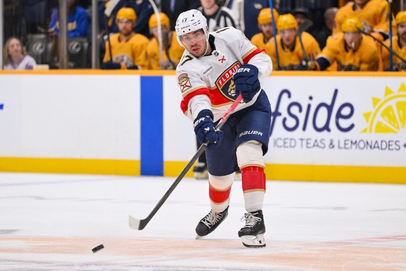 Nov 24, 2025; Nashville, Tennessee, USA;  Florida Panthers center Evan Rodrigues (17) passes the puck against the Nashville Predators during the second period at Bridgestone Arena. Mandatory Credit: Steve Roberts-Imagn Images