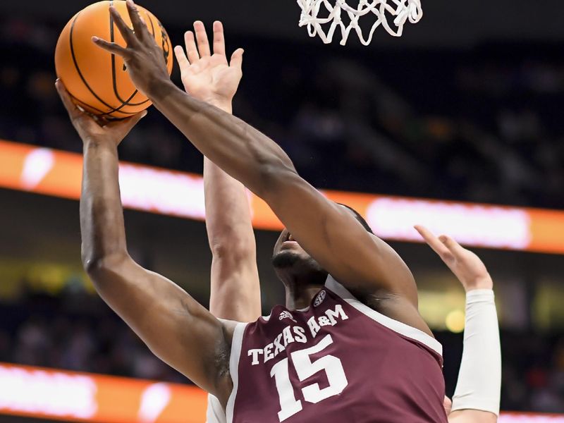 Mar 16, 2024; Nashville, TN, USA;  Texas A&M Aggies forward Henry Coleman III (15) scores from under the basket against the Florida Gators during the first half at Bridgestone Arena. Mandatory Credit: Steve Roberts-USA TODAY Sports