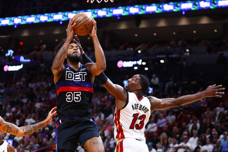 MIAMI, FLORIDA - OCTOBER 25: Marvin Bagley III #35 of the Detroit Pistons drives against Bam Adebayo #13 of the Miami Heat during the third quarter of the game at Kaseya Center on October 25, 2023 in Miami, Florida. NOTE TO USER: User expressly acknowledges and agrees that, by downloading and or using this photograph, User is consenting to the terms and conditions of the Getty Images License Agreement.  (Photo by Megan Briggs/Getty Images)