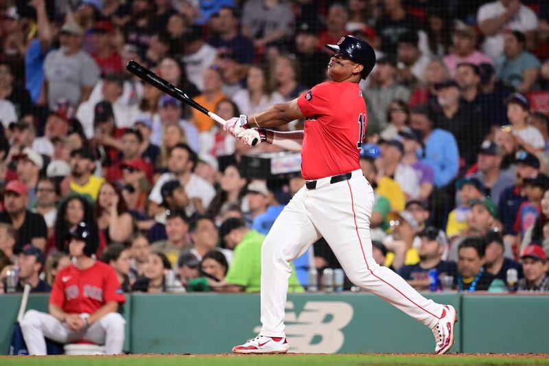 Jun 28, 2024; Boston, Massachusetts, USA; Boston Red Sox third baseman Rafael Devers (11) hits a home run against the San Diego Padres during the sixth inning at Fenway Park. Mandatory Credit: Eric Canha-USA TODAY Sports