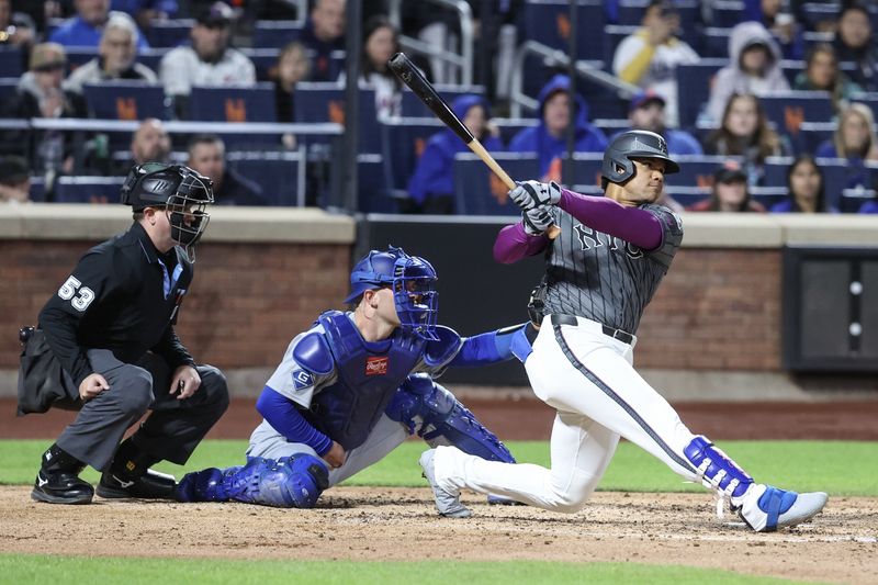 May 24, 2025; New York City, New York, USA;  New York Mets right fielder Juan Soto (22) hits a two run double in the fourth inning against the Los Angeles Dodgers at Citi Field. Mandatory Credit: Wendell Cruz-Imagn Images