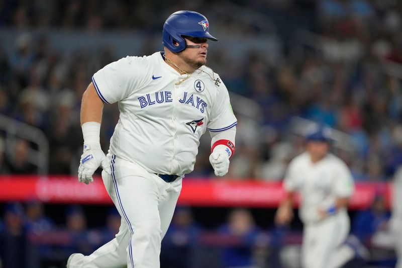 Jun 2, 2024; Toronto, Ontario, CAN; Toronto Blue Jays designated hitter Daniel Vogelbach (20) runs to first base on his two-run double against the Pittsburgh Pirates during the fifth inning at Rogers Centre. Mandatory Credit: John E. Sokolowski-USA TODAY Sports